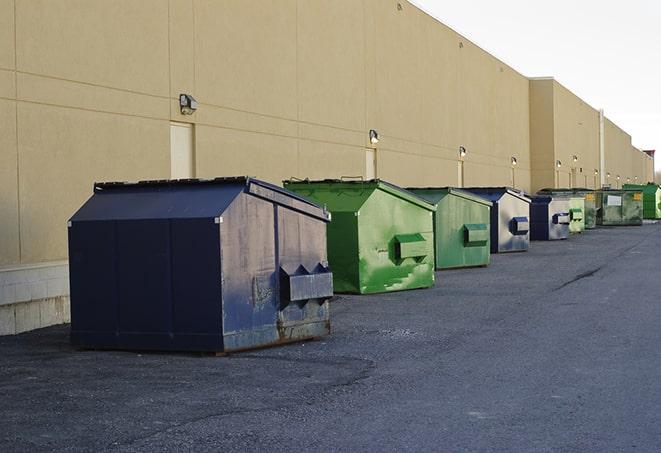 a fleet of red and blue construction dumpsters available for use in Garwood NJ